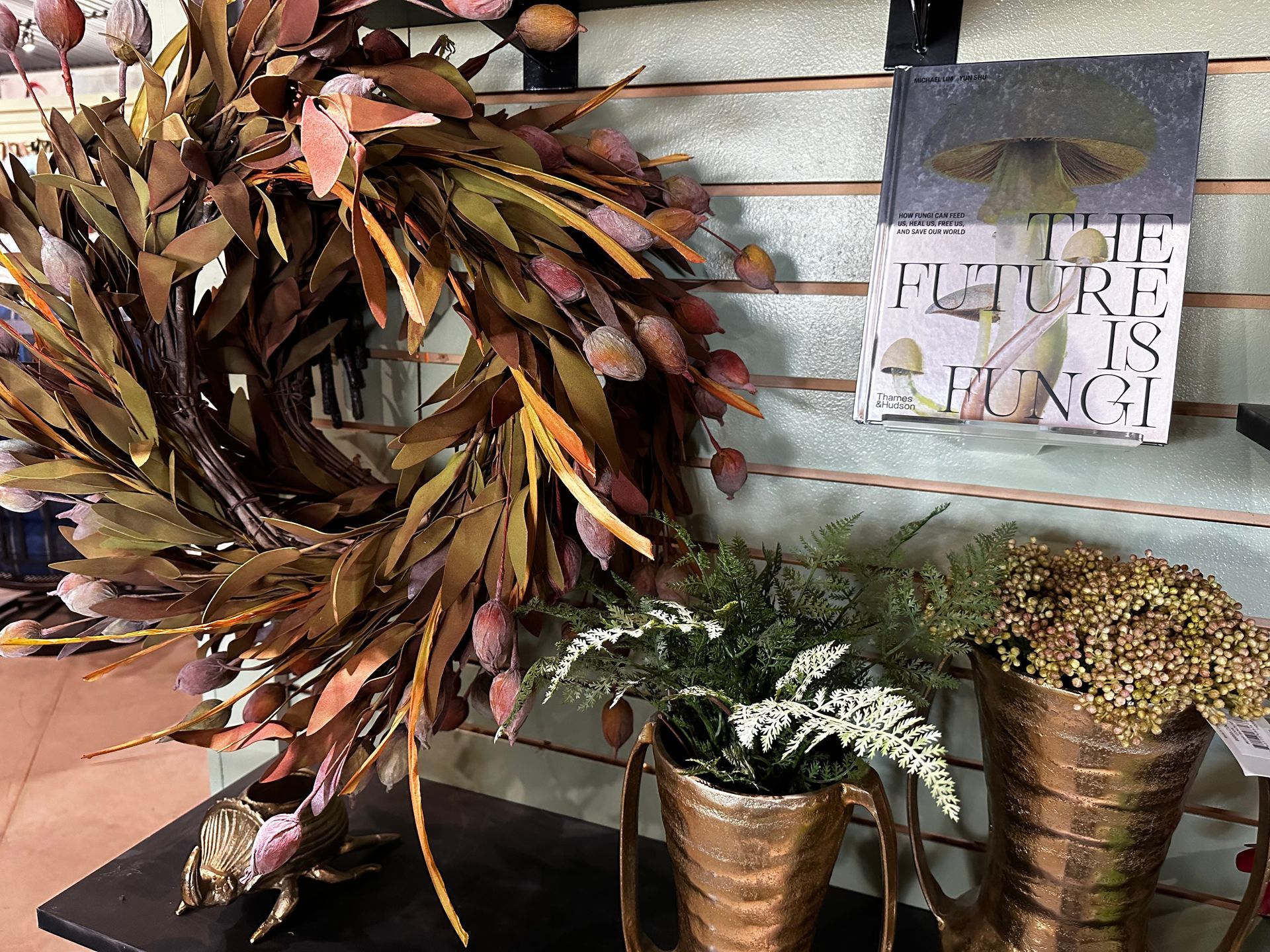 A wreath is sitting on a table next to a sign that says the future is bright.