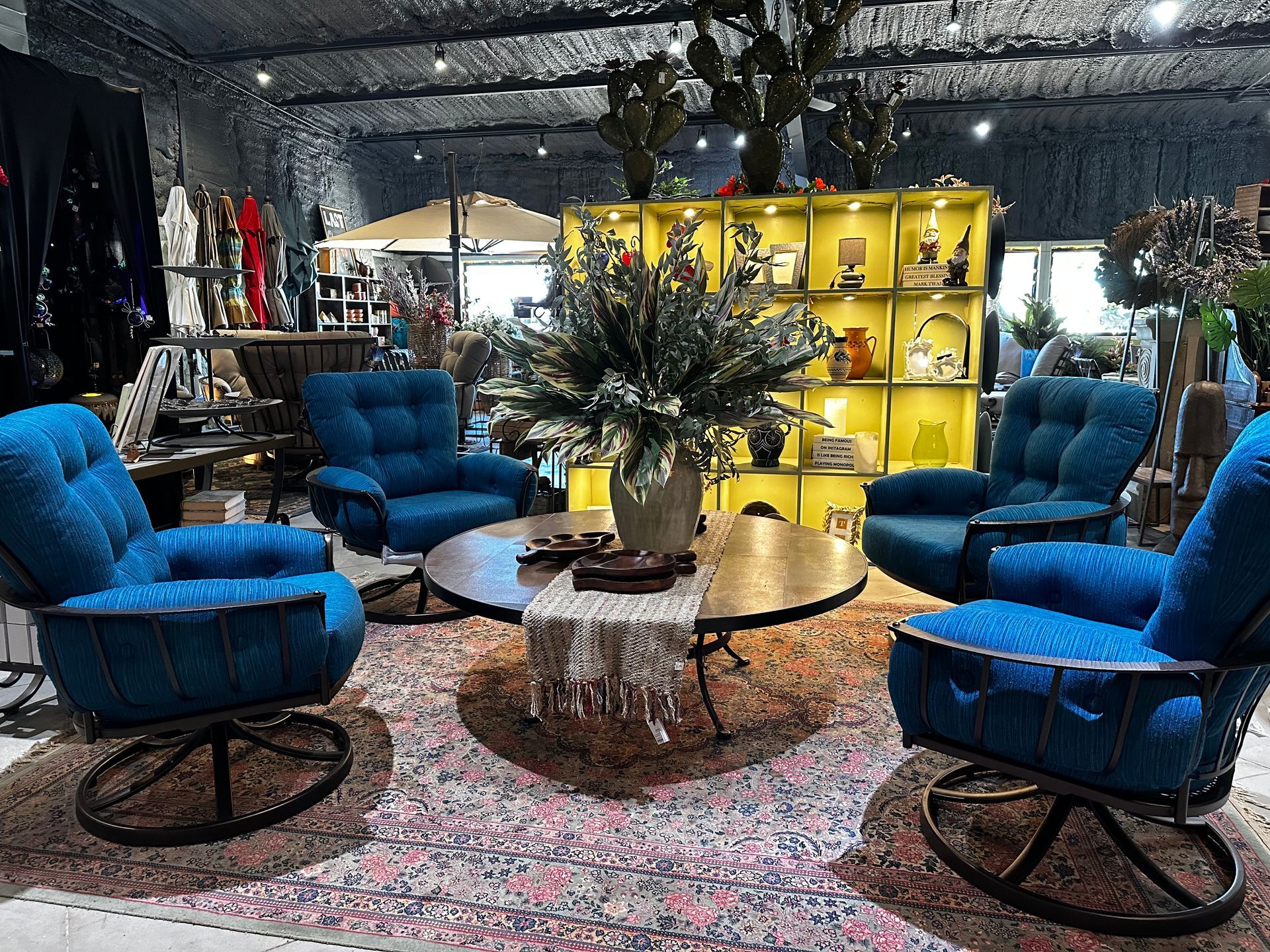 A living room with blue chairs and a coffee table.