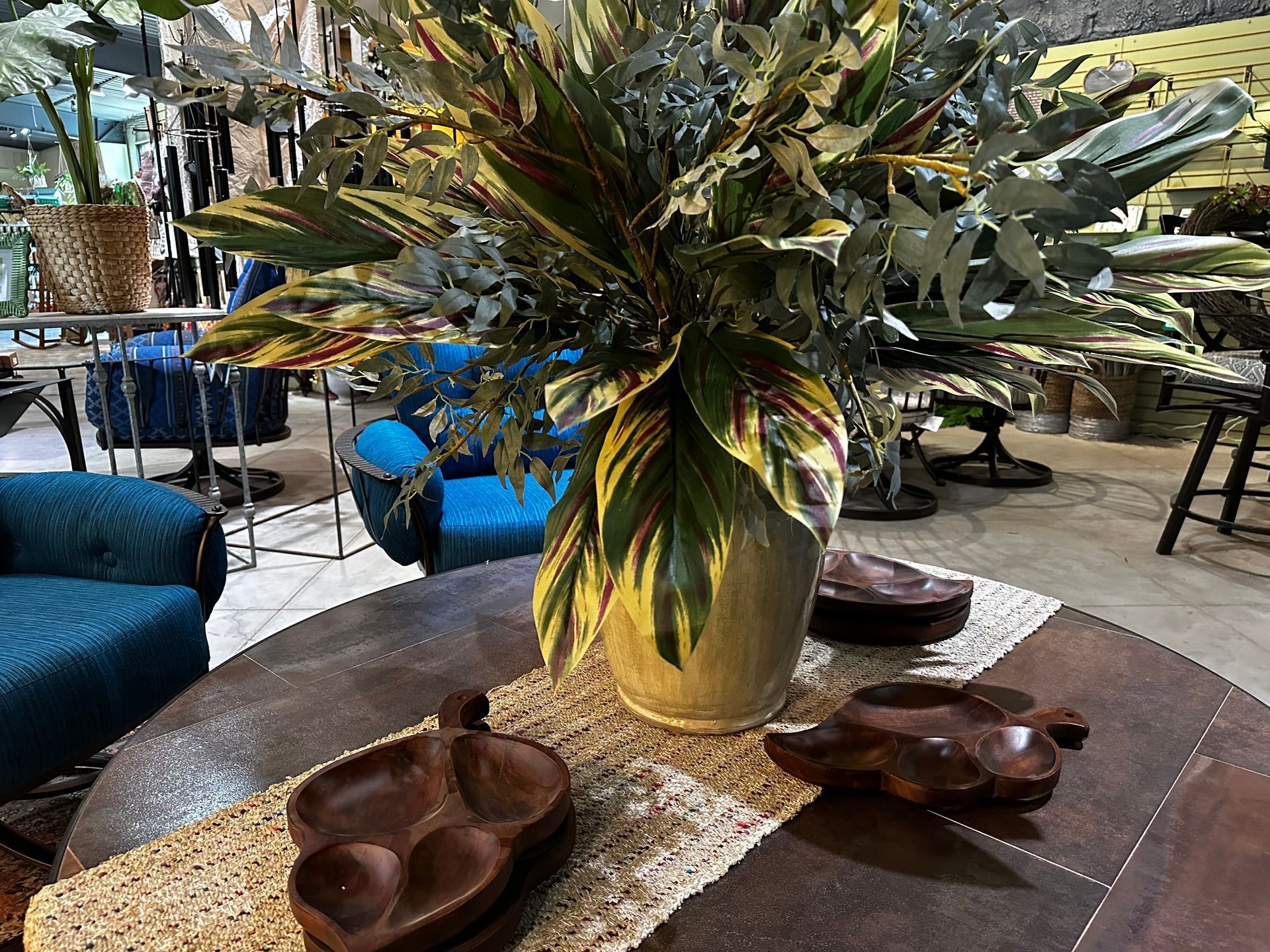 A vase of flowers is sitting on a table in a living room.