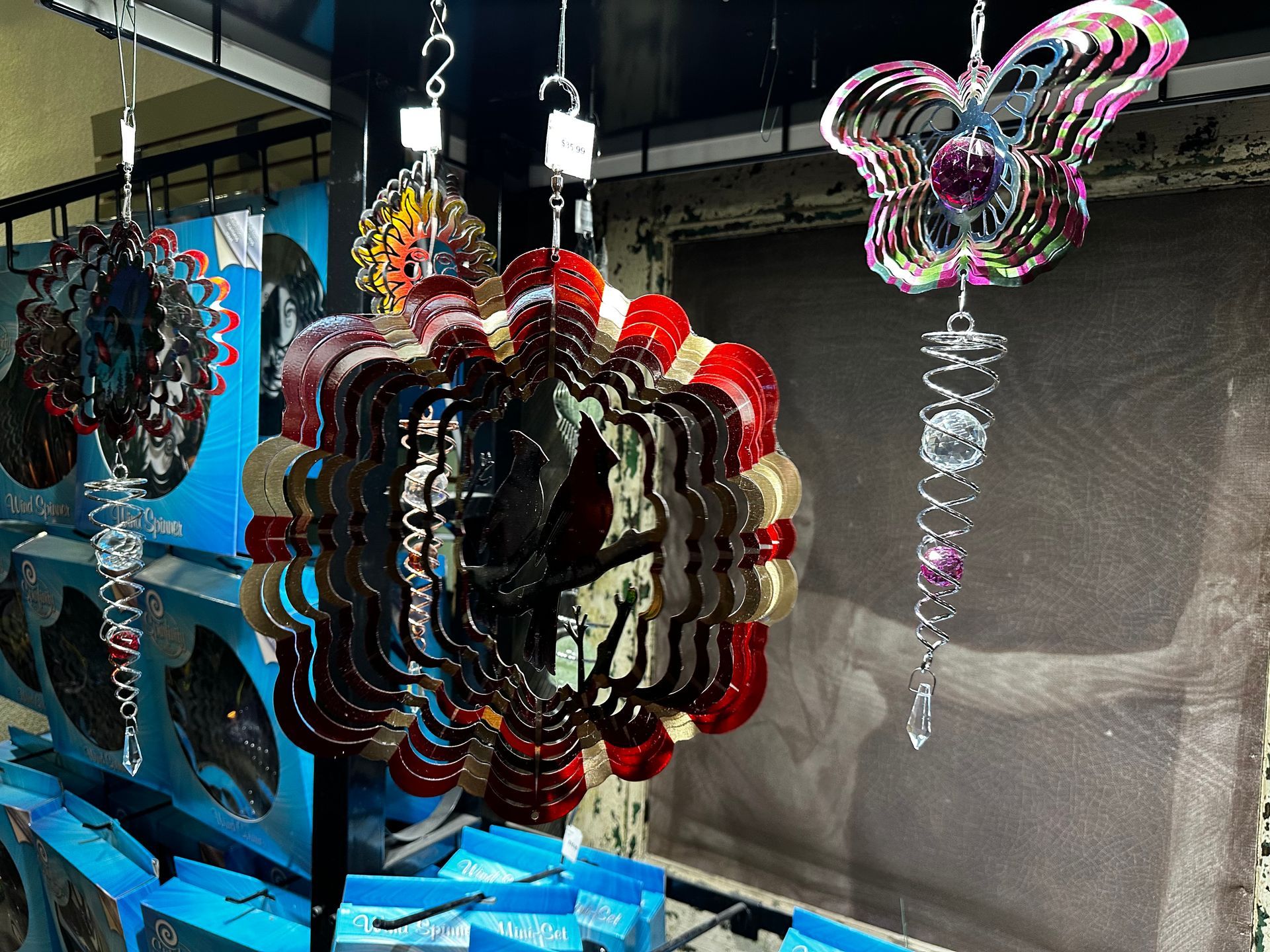 A bunch of colorful wind spinners hanging from the ceiling