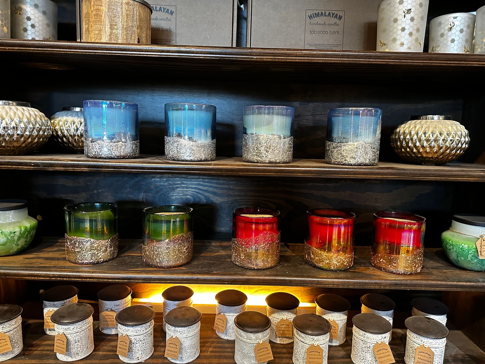 A shelf with candles and vases on it
