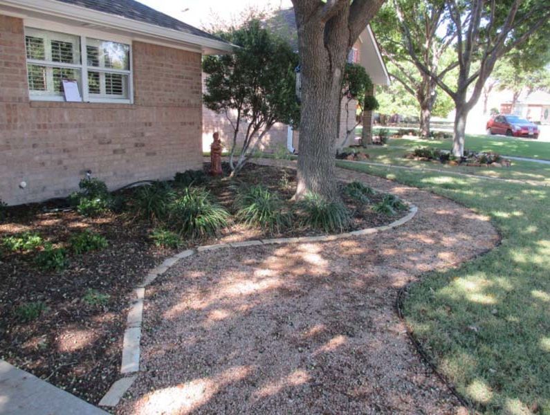 A brick house with a tree in front of it