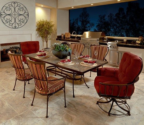 A dining room with a table and chairs and a grill