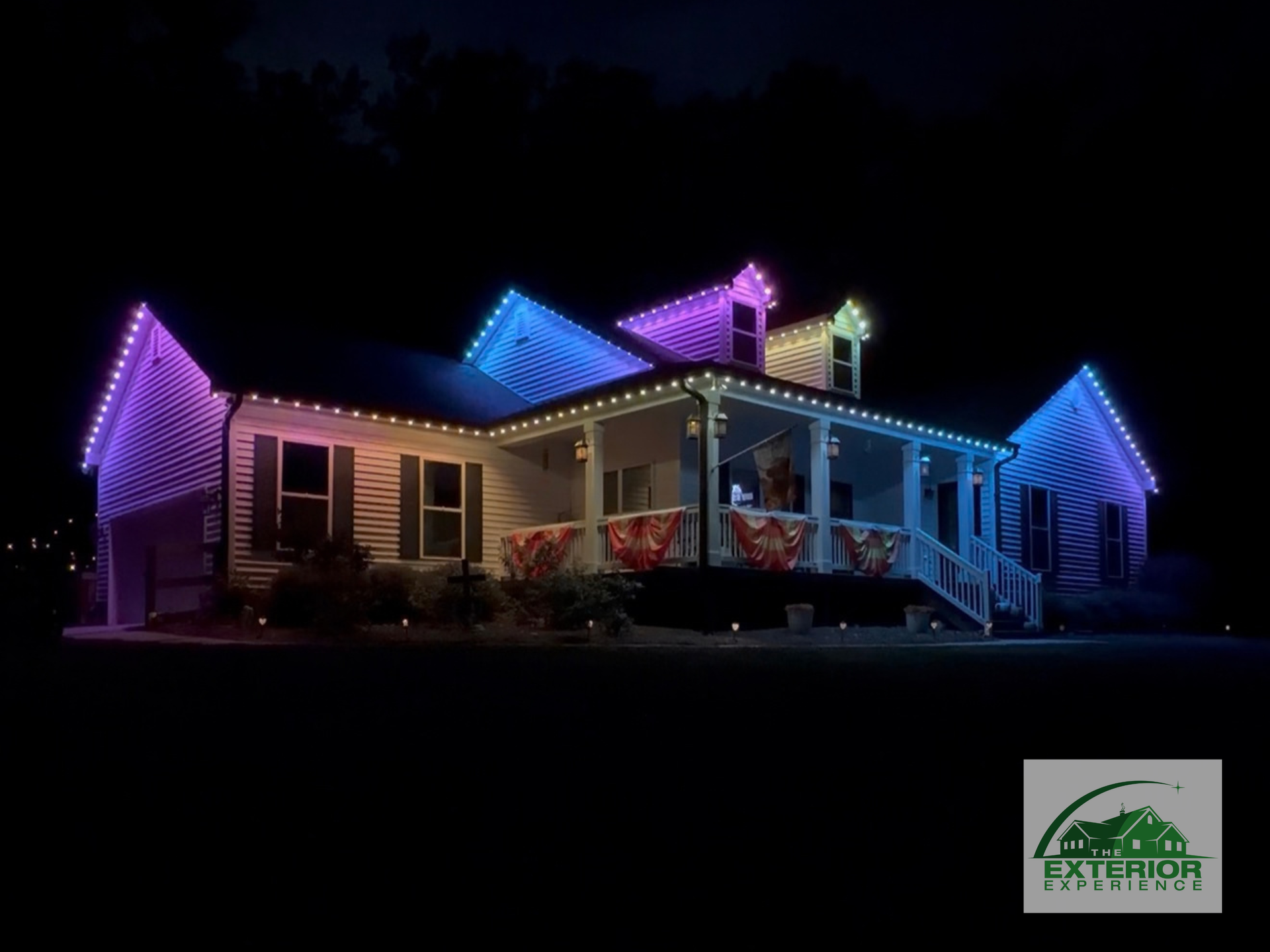 House decorated with colorful Christmas lights at night