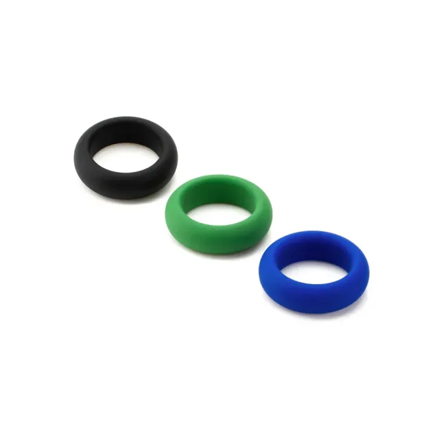 Three different coloured rings are lined up on a white surface.