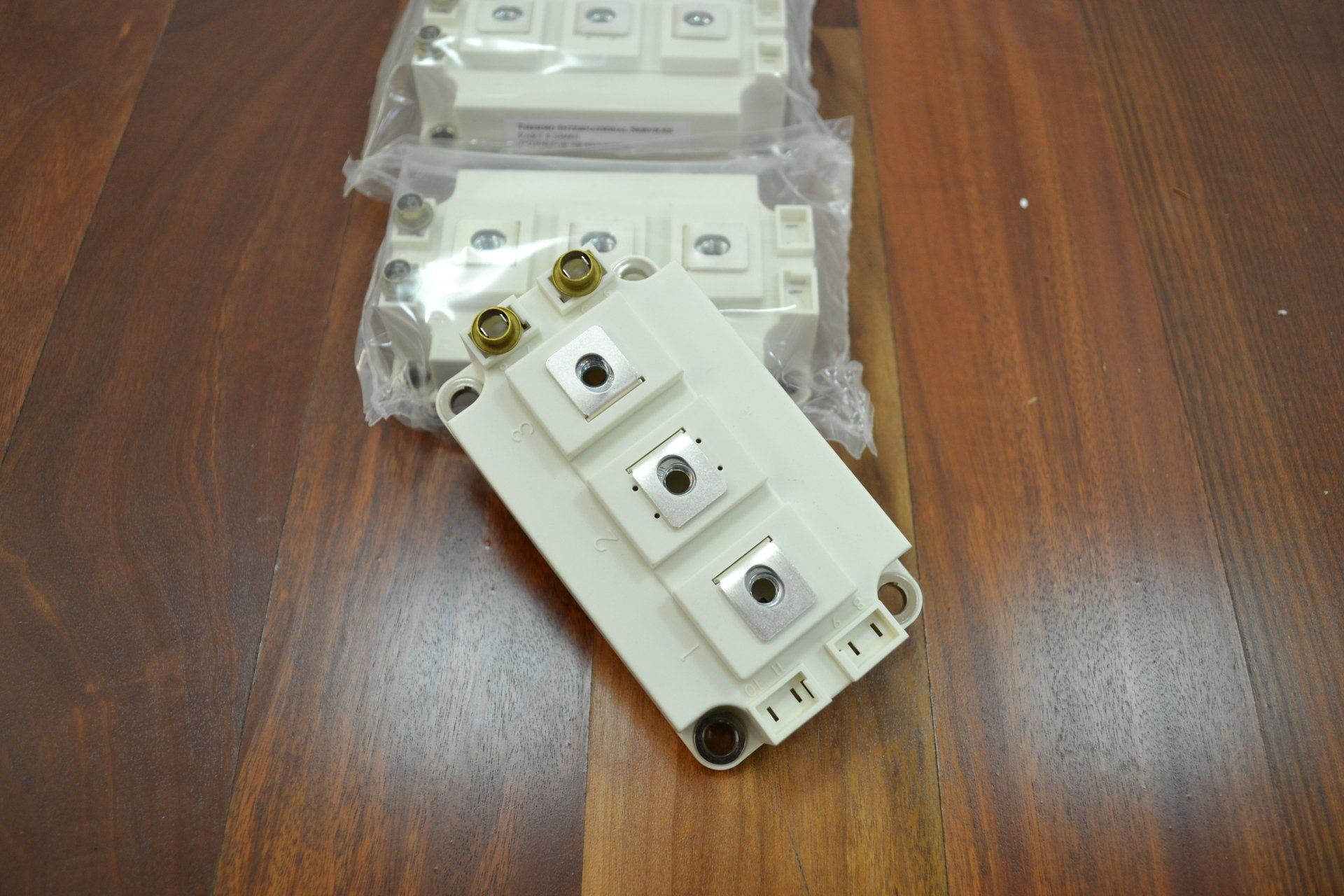 A white electronic device is sitting on a wooden table.