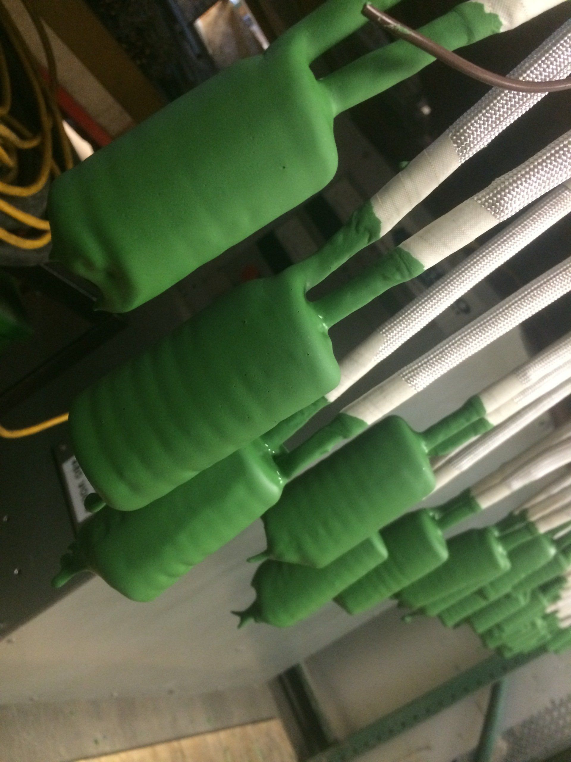 A bunch of green and white wires are lined up