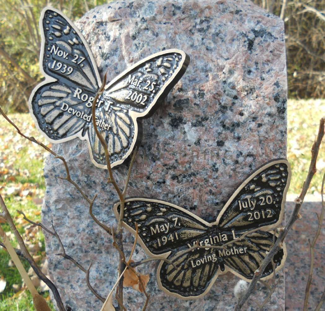 Gravestone with butterfly plaques; names, dates engraved: