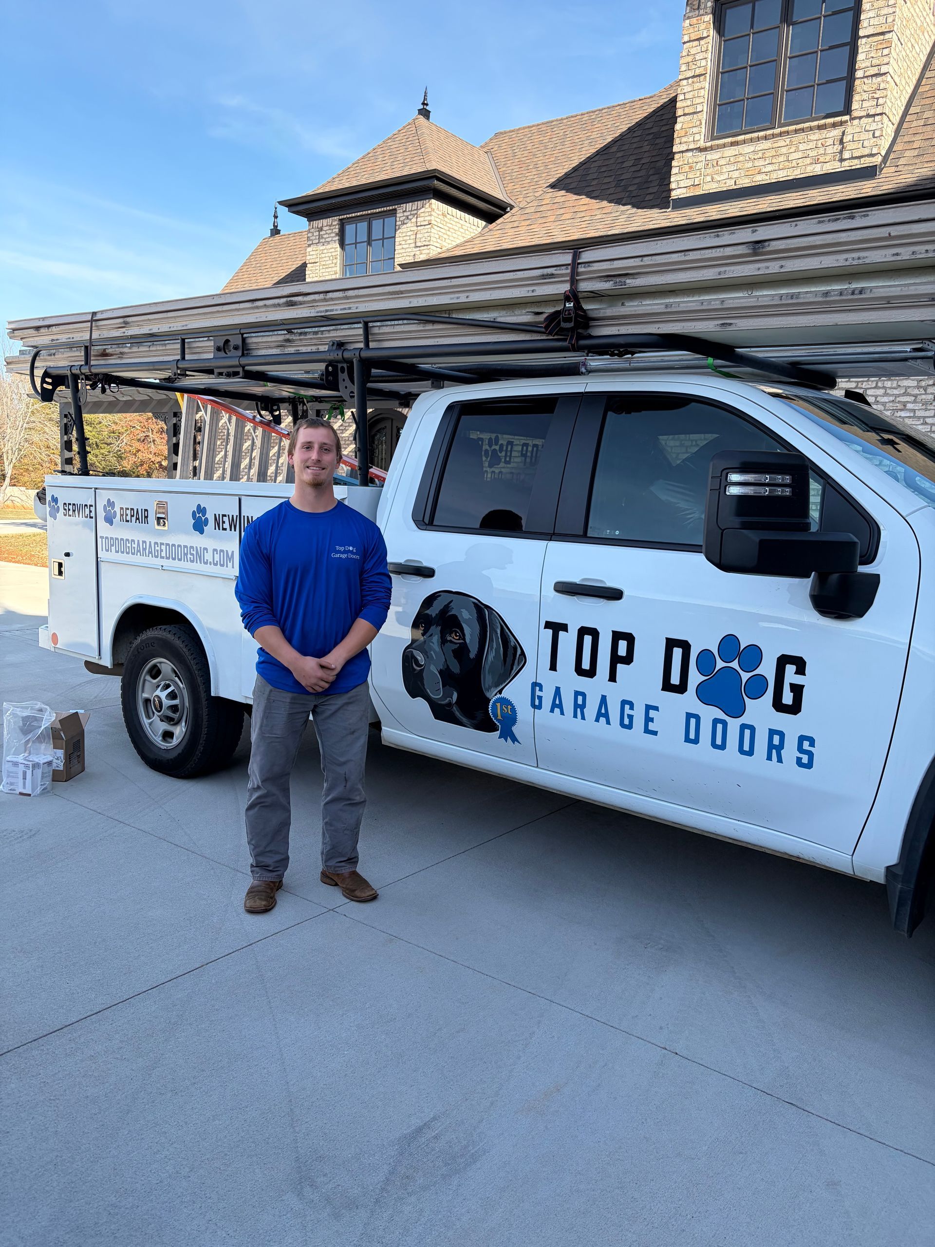 Man stands in front of a white truck with 