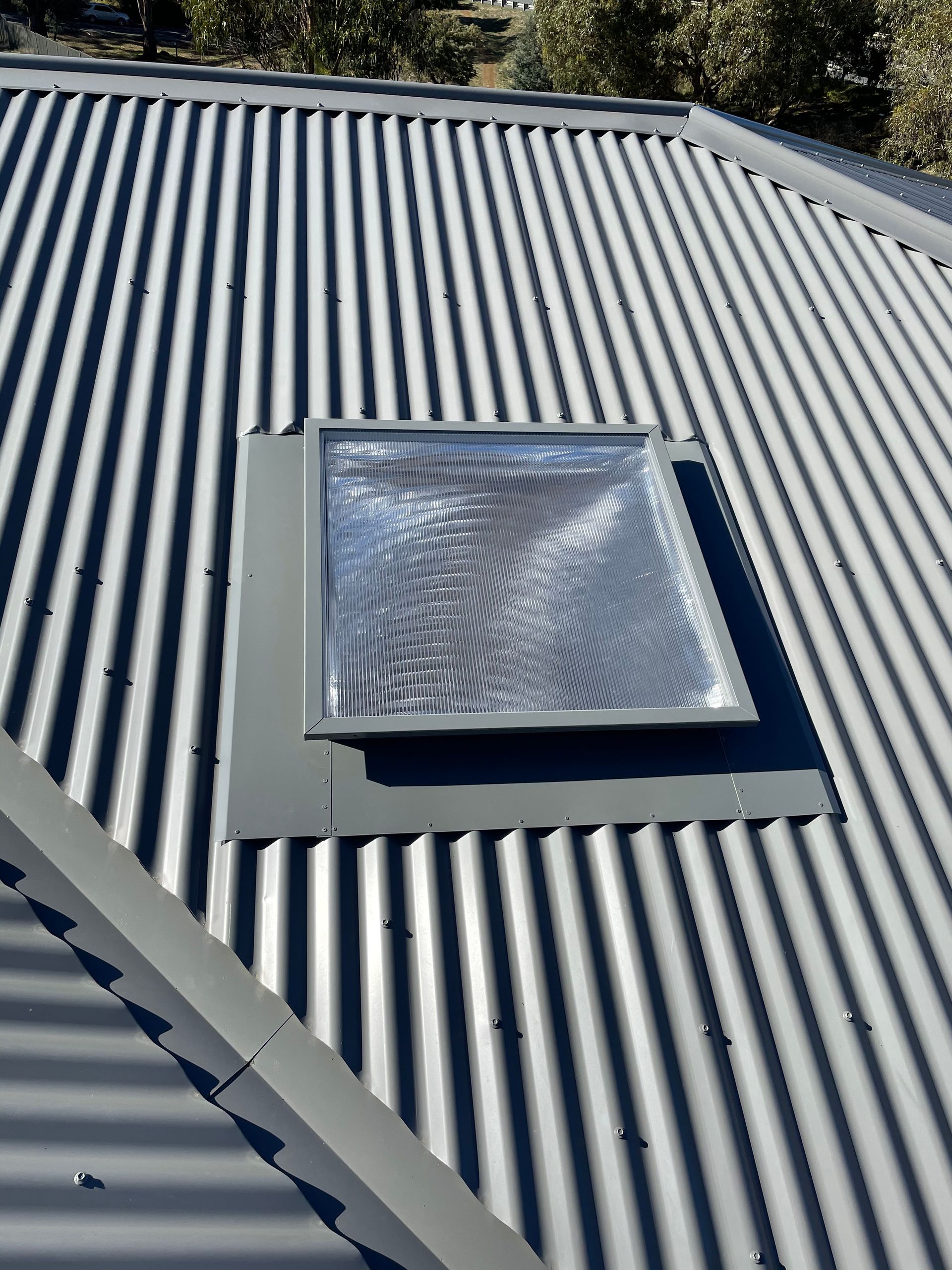 There is a skylight on the roof of a house.