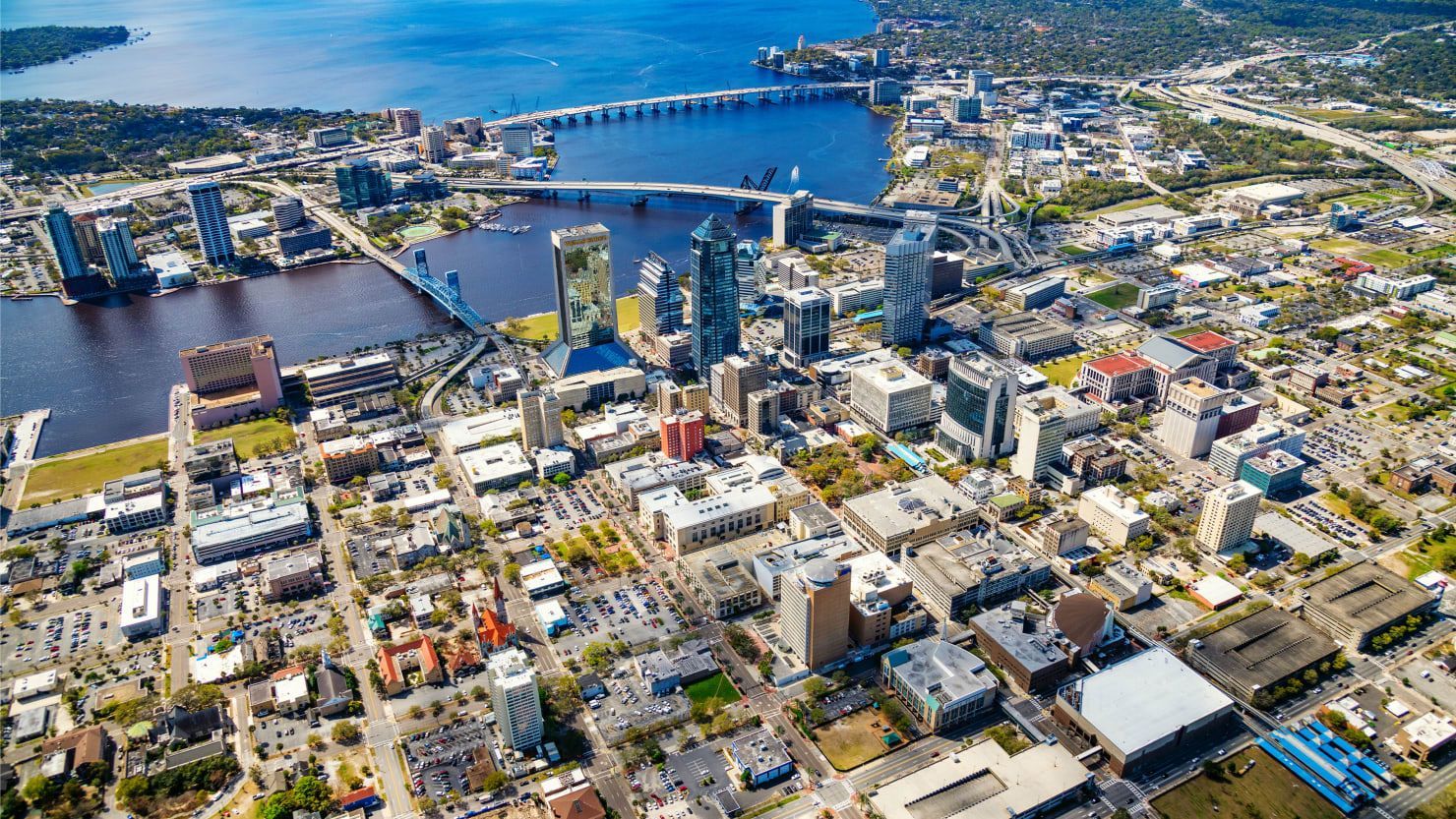 An aerial view of a city surrounded by water and buildings.