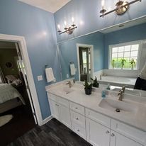 A bathroom with two sinks and a large mirror.
