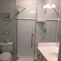 A bathroom with a toilet , sink , and shower stall.