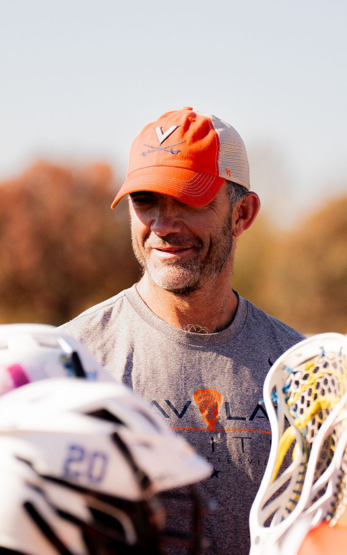 Headshot of CAV Lax Elite boys coach in white checkered shirt, smiling