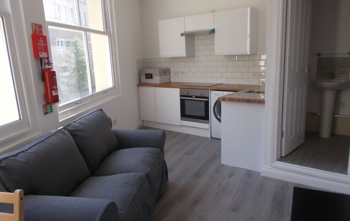 a kitchen with a fire extinguisher on the wall