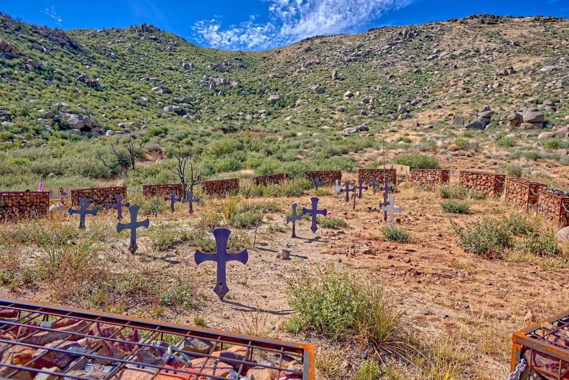 A cemetery with crosses in the middle of a desert.