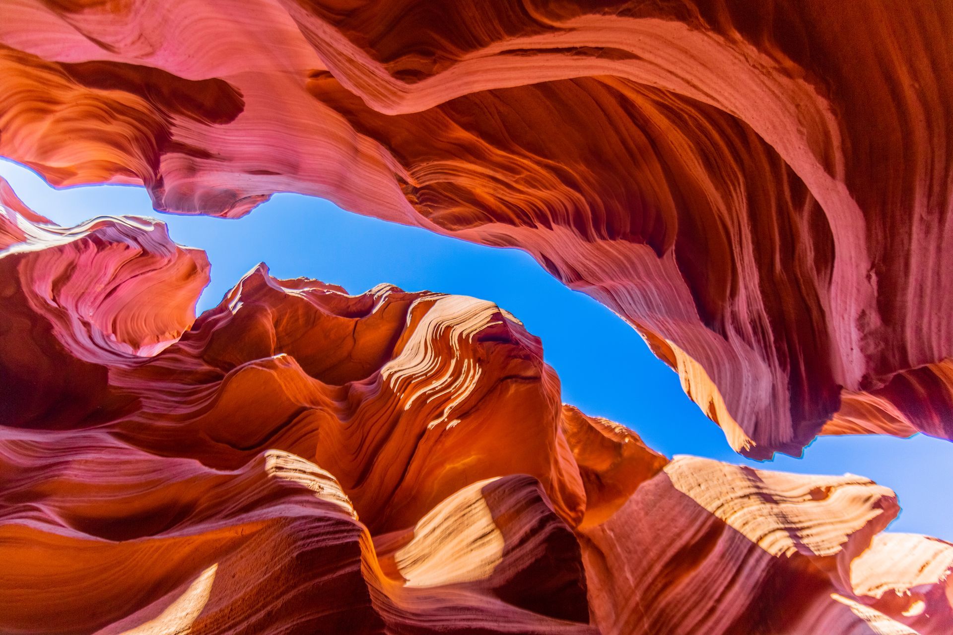 Looking up at a canyon with a blue sky in the background.