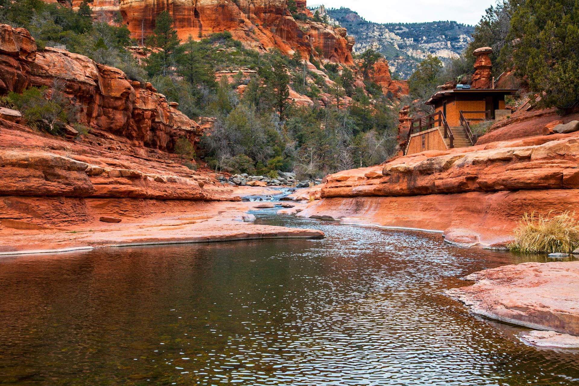 A river flowing through a canyon surrounded by rocks and trees