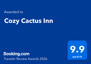 Booking.com award for Cozy Cactus Inn. Blue background with white text, rating 9.9 out of 10.