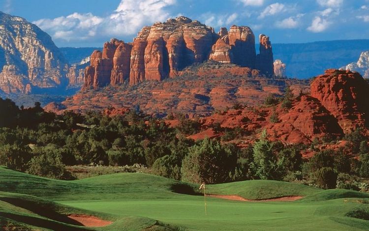 A golf course with a mountain in the background