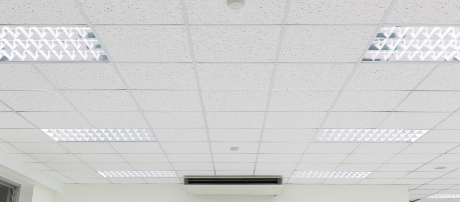 White office ceiling with fluorescent lights and vents
