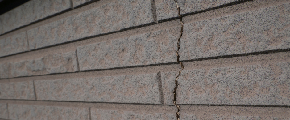 Close-up of a gray brick wall with horizontal mortar lines