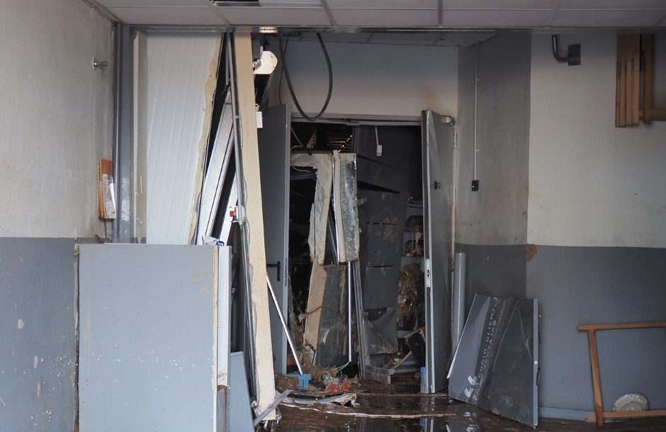 Damaged interior doorway with debris and collapsed structures, likely caused by damage or destruction.