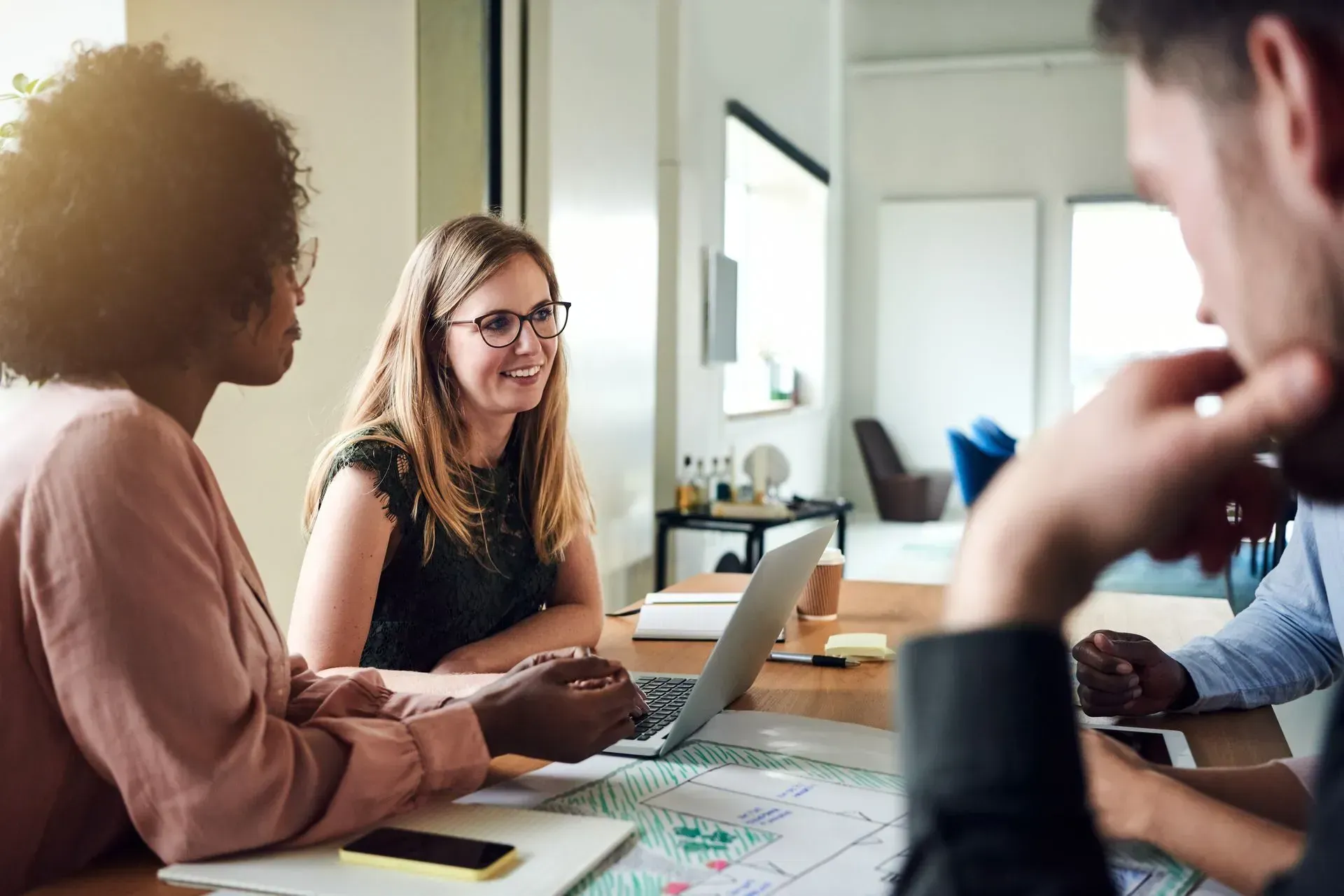 a web designer in a meeting with clients