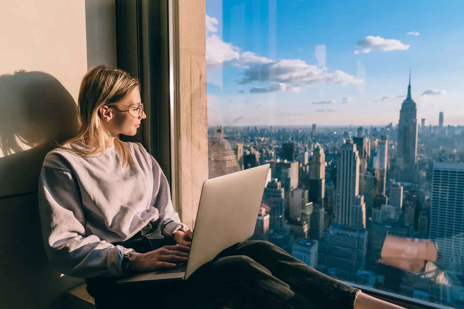 woman by a window with city views