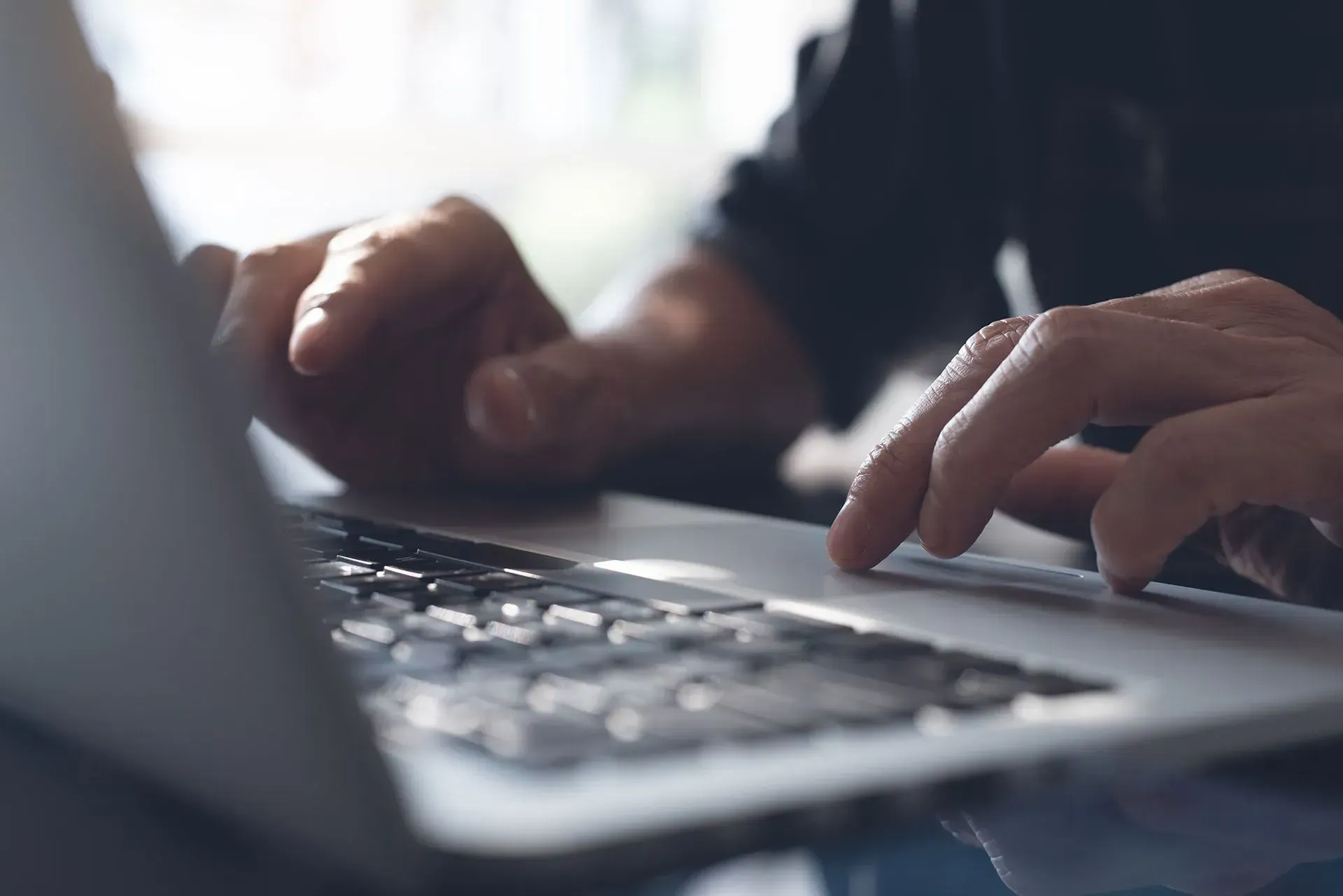 Man Typing on Laptop