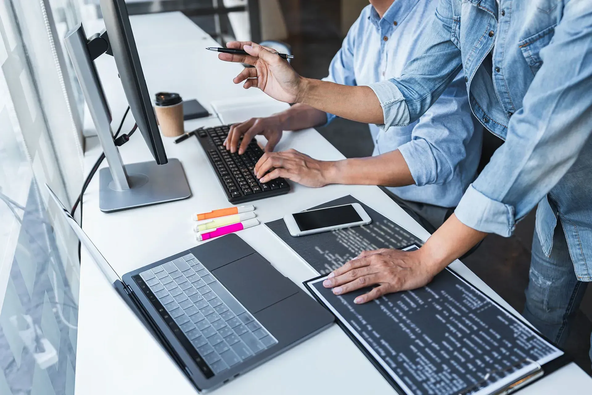 two people working on a computer