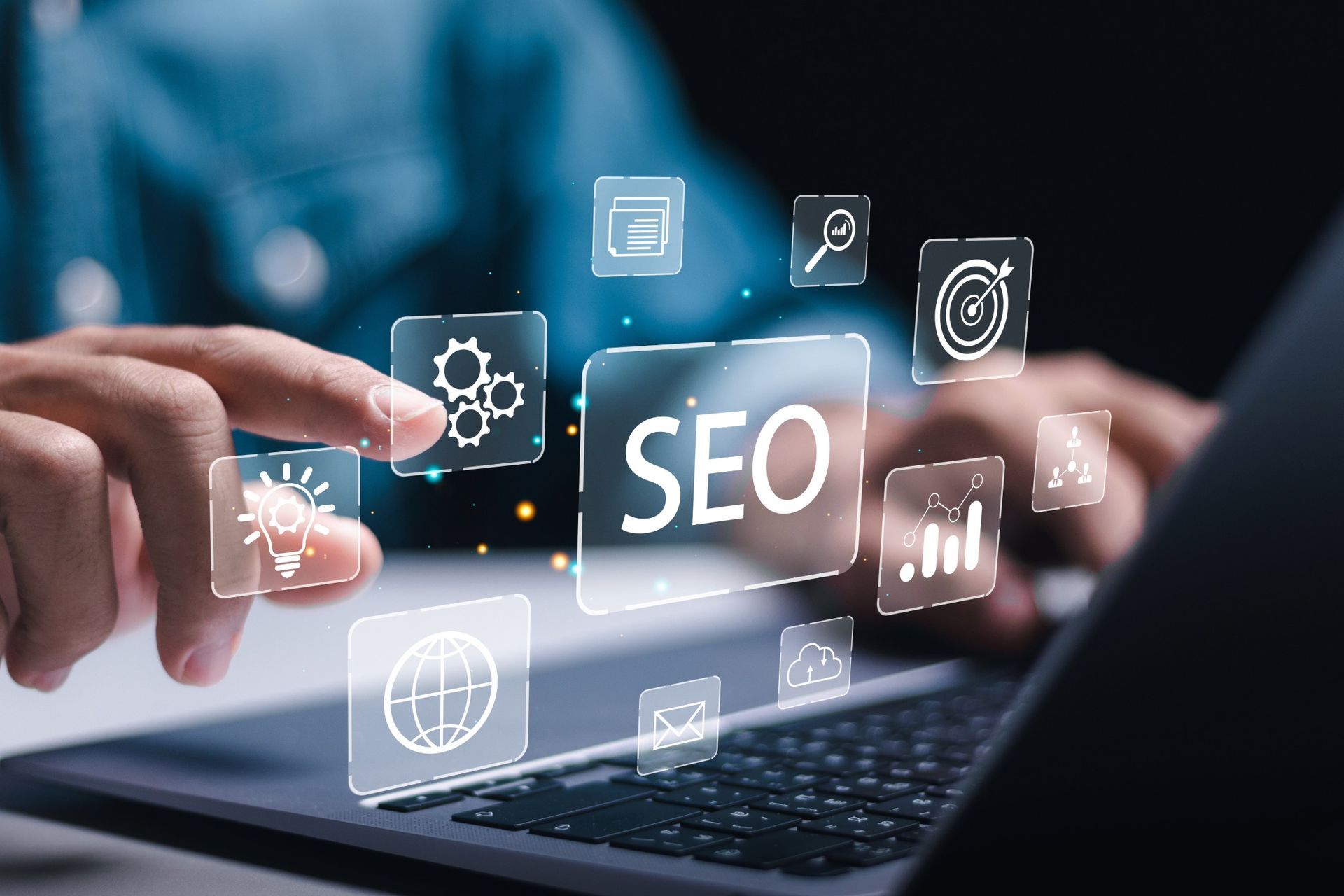 Person using a laptop with digital SEO icons overlayed.