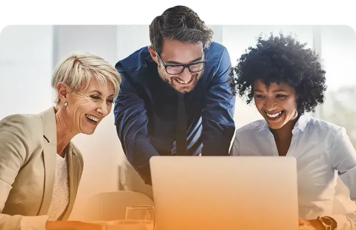 three professionals looking at laptop