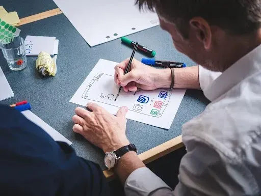 a man doing a mockup of an app design