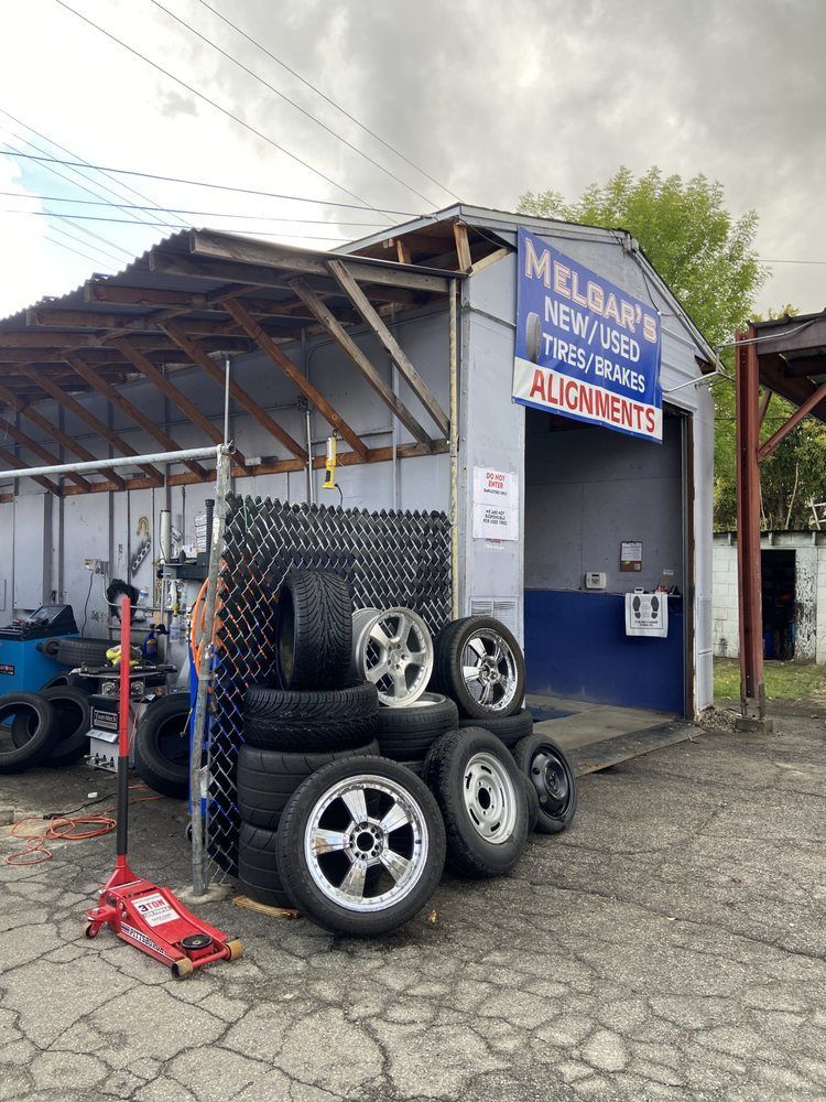 A small auto repair shop exterior with a sign for