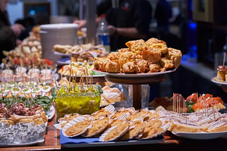 Gourmet buffet table with appetizers and finger foods at a catered event