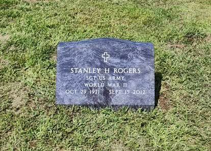Granite grave marker in grass for Stanley R. Rogers, U.S. Army World War II, with cross symbol.