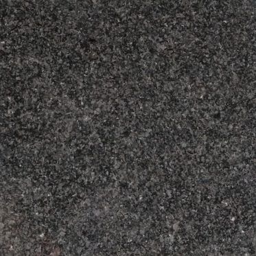 Dark gray speckled textured surface, close-up.
