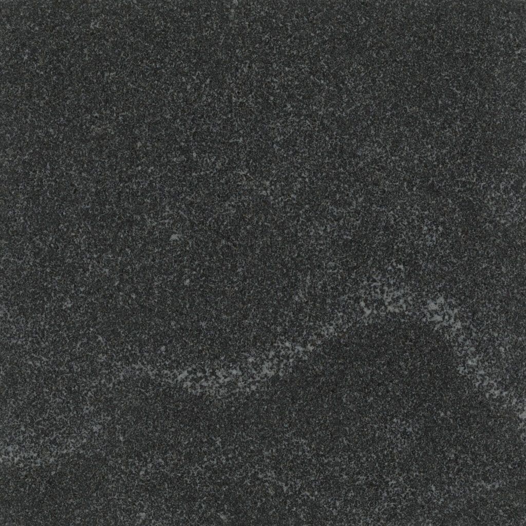 Dark, grainy abstract texture with a faint diagonal streak of lighter gray.