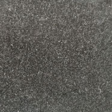 Close-up of a dark gray speckled stone or textured surface