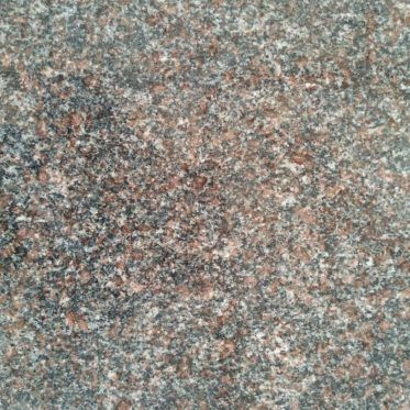 Speckled gray, pink, and black granite surface texture