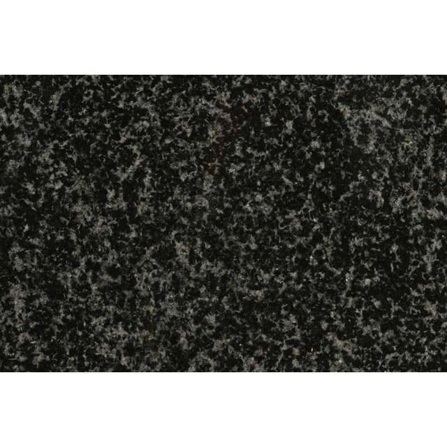 Dark speckled black-and-gray textured surface with a narrow white border