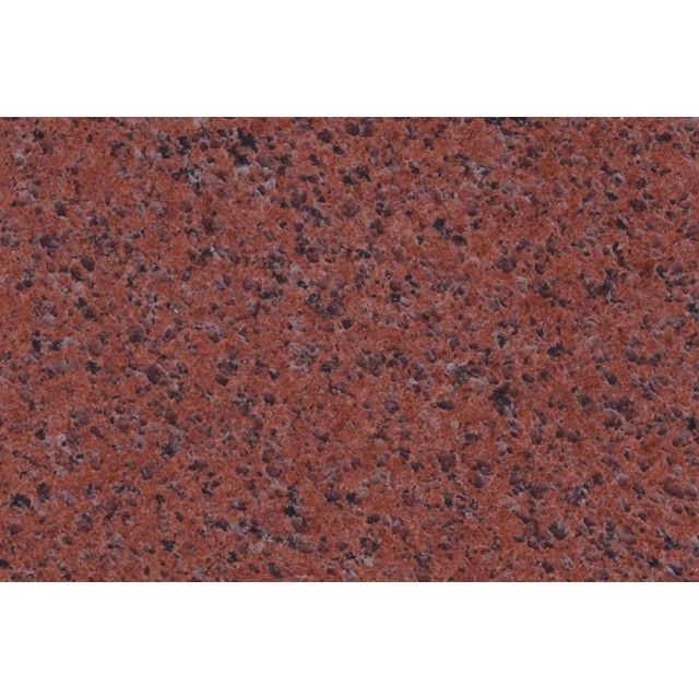 Close-up of red speckled granite stone surface
