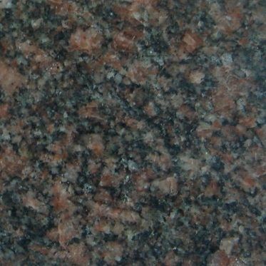 Close-up of dark speckled granite countertop with pink, black, and gray flecks