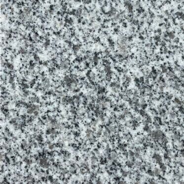 Close-up of gray speckled granite or stone surface with black and white flecks