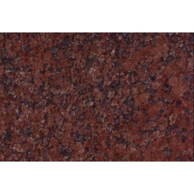Close-up of a red and black speckled stone surface, like granite countertop texture