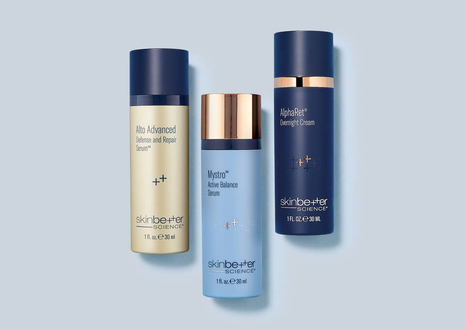 Three bottles of cosmetics are sitting next to each other on a table.