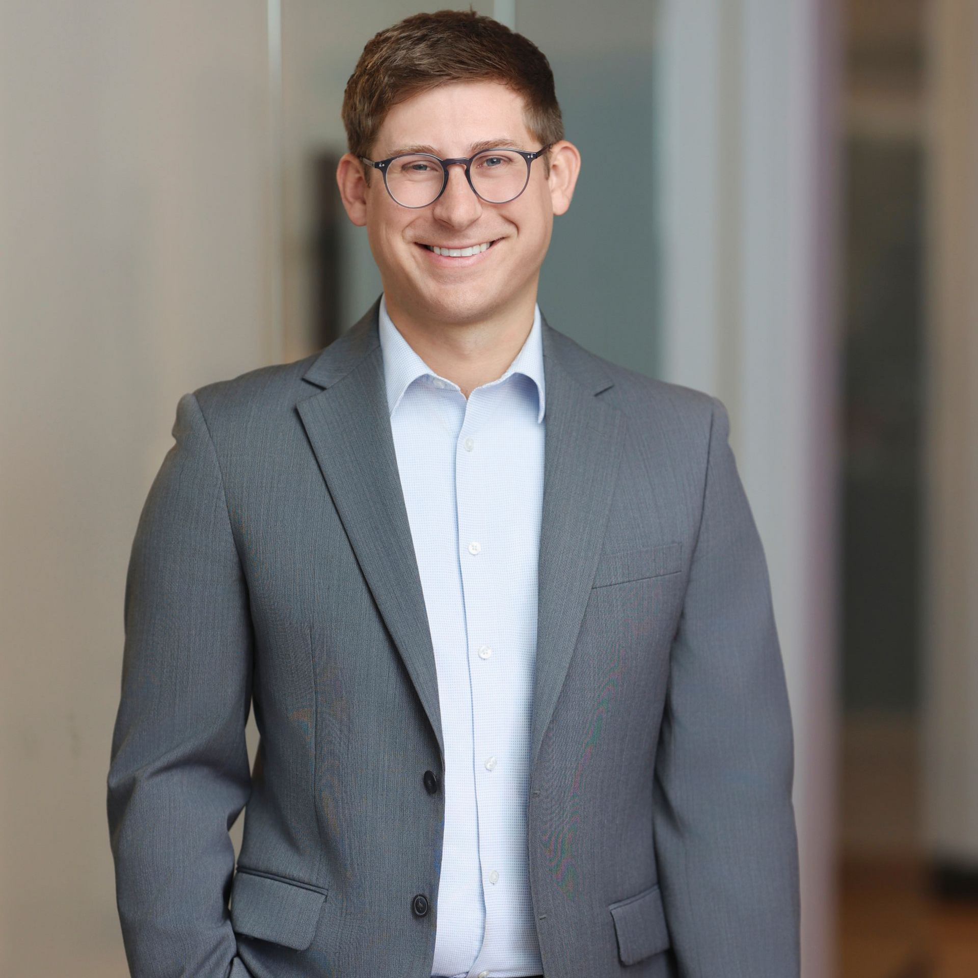 a personal injury attorney in a suit and tie is adjusting his tie