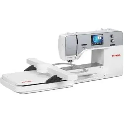 White sewing machine with extension table and digital display on a plain background