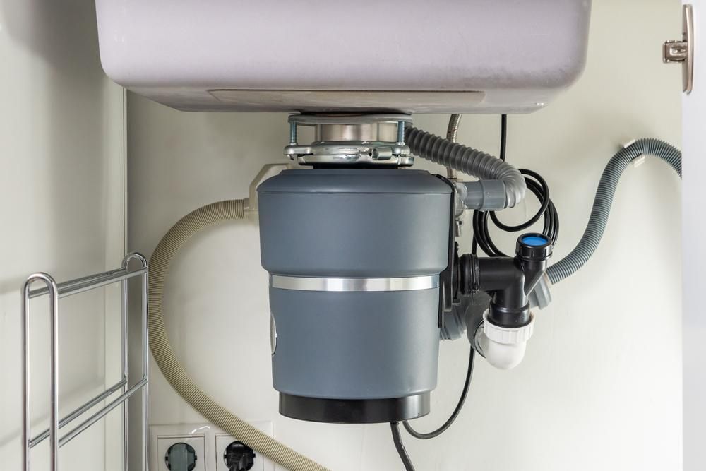 A Garbage Disposal Is Under a Sink in A Kitchen — Top To Bottom Plumbing in Garbutt, QLD